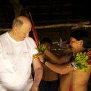 Daví Kopenawa attaches macaw feathers to King Harald&#146;s arm just prior to departure. This is held to be a special badge of honour. Published 4 May 2013. Handout picture from the Royal Court. For editorial use only, not for sale. Photo: Rainforest Foundation Norway / ISA Brazil.
